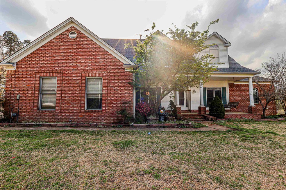 View of front of property with brick siding and a 