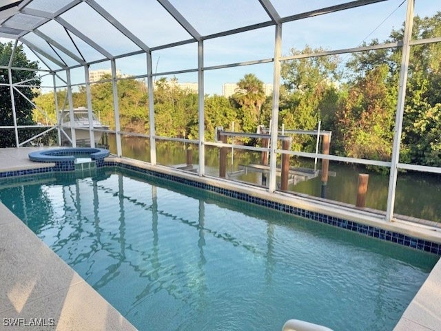 View of swimming pool featuring glass enclosure an