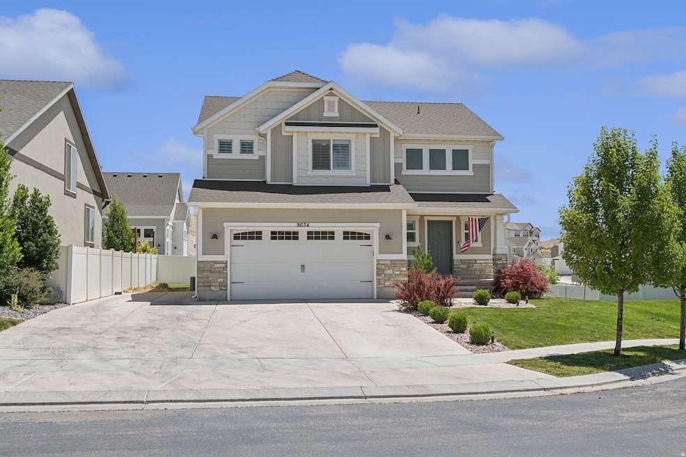 Craftsman inspired home with stone siding, a garage, driveway, and roof with shingles