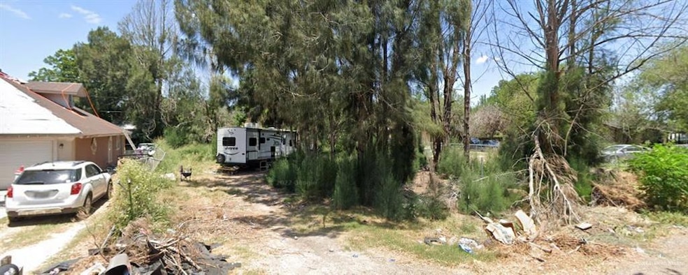 View of yard with a garage and driveway