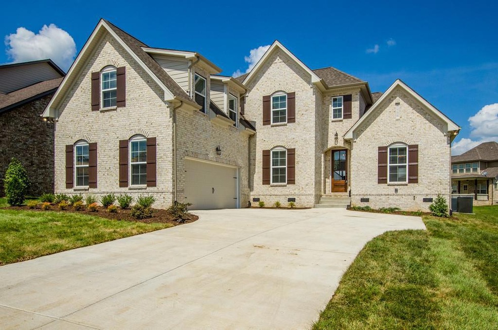 Mostly Brick Exterior with courtyard driveway and side entry 2 car garage - These are not actual pictures of home under construction
