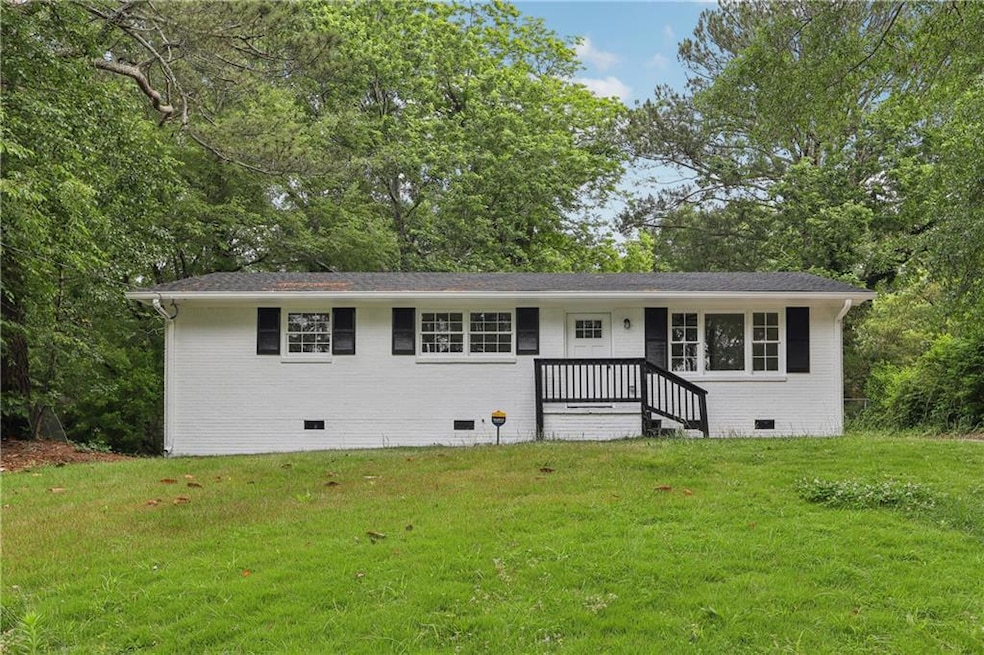 Ranch-style house featuring crawl space, a front yard, and brick siding