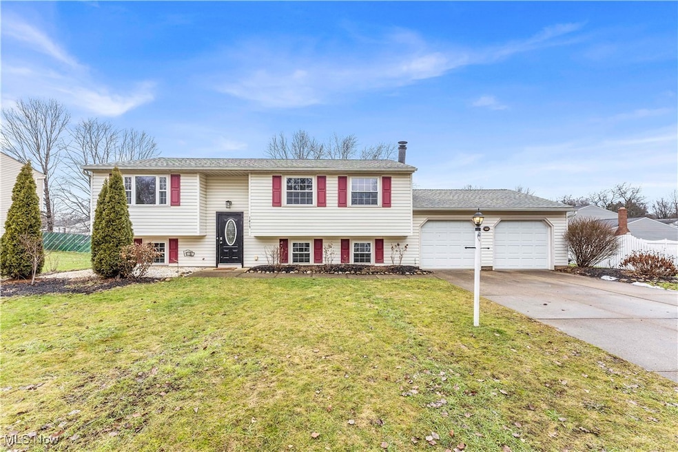 Raised ranch with a garage and a front lawn