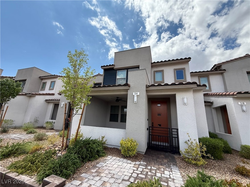 View of front facade with a ceiling fan, a tiled r