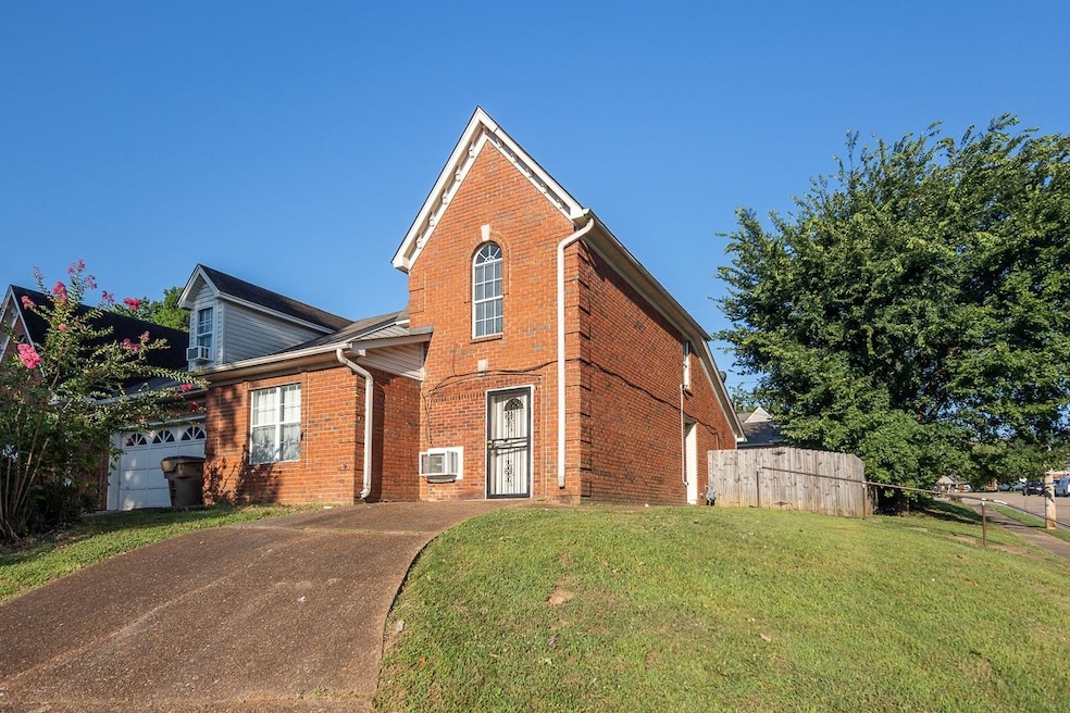 View of property with a garage and a front yard