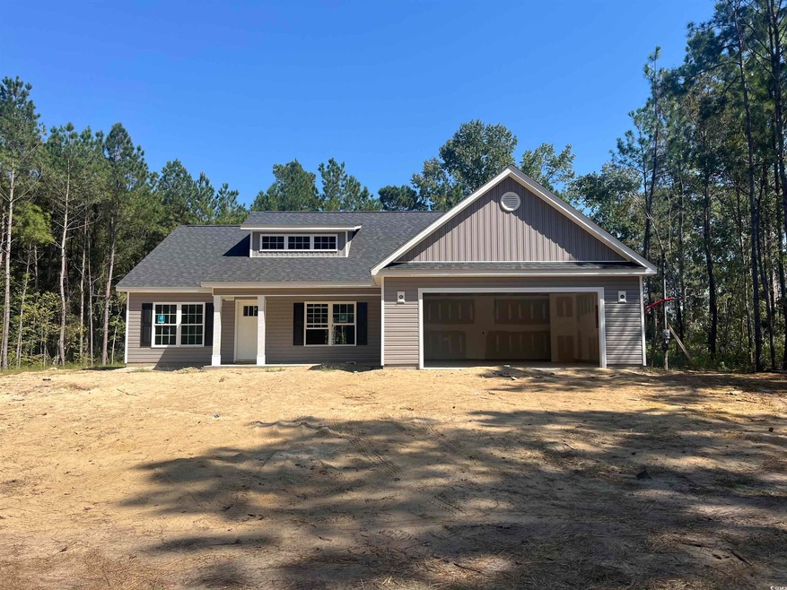 View of front facade featuring covered porch, an attached garage, a shingled roof, and driveway