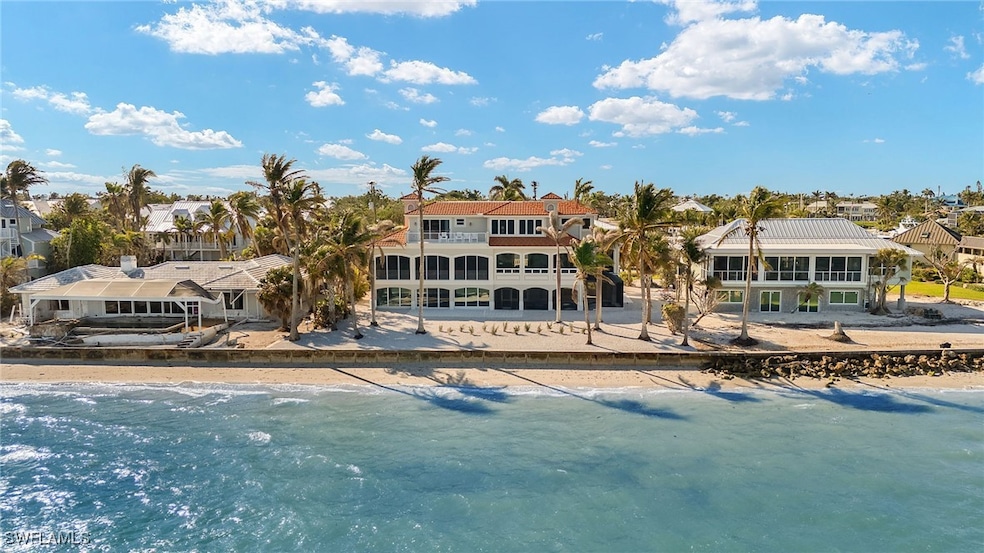 Rear view of house with a view of the beach and a