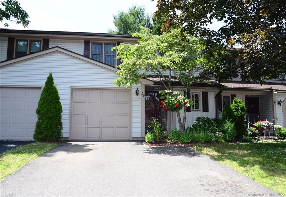 Front view with driveway for multiple cars.
