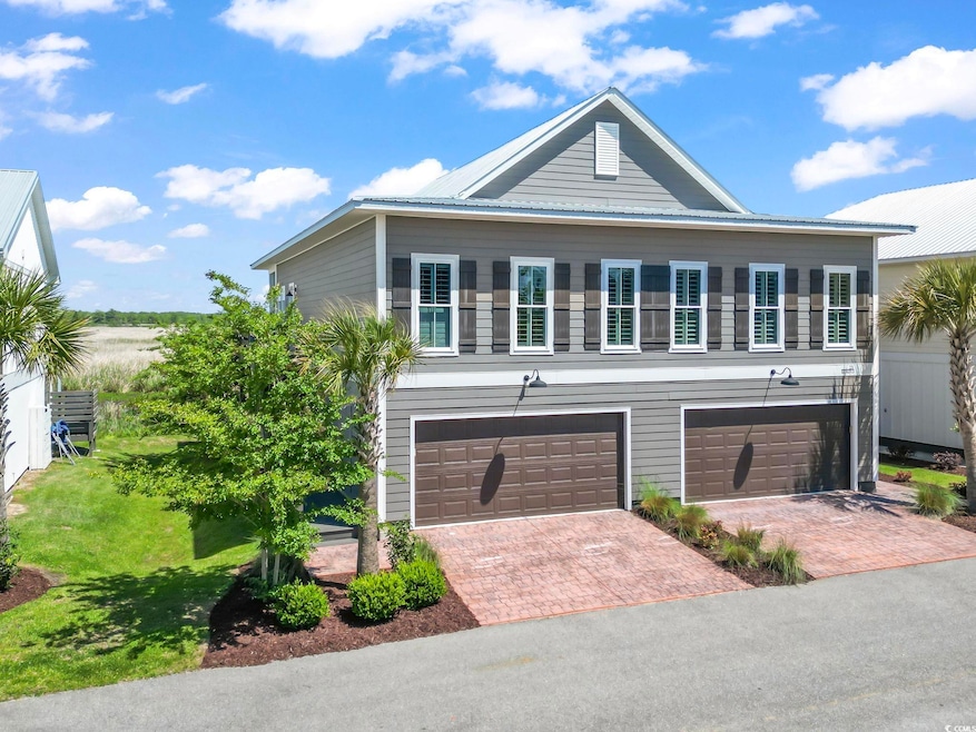View of front facade with a garage, a front lawn, 