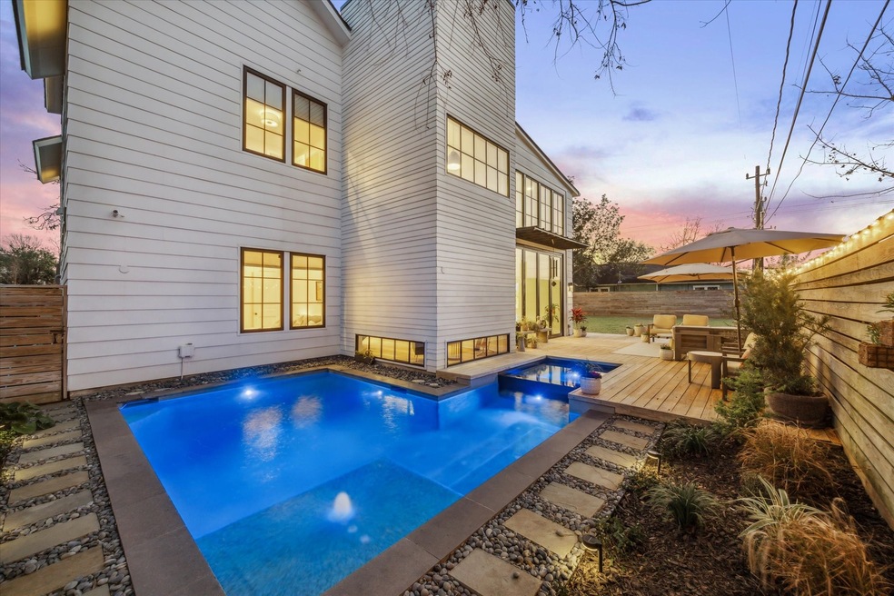Welcome to 205 E 25th! This impeccable 4 bedroom/4