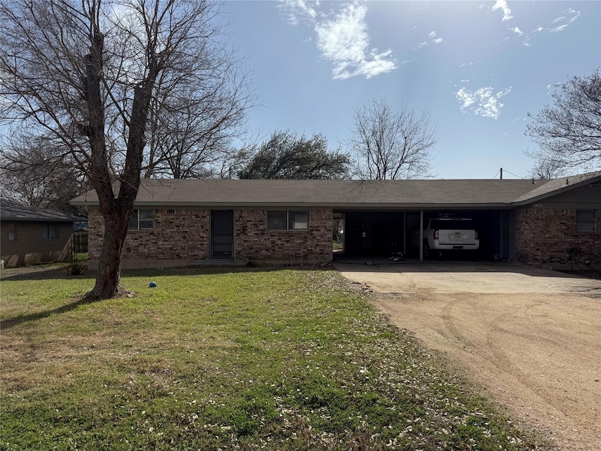Ranch-style home with brick siding, an attached c