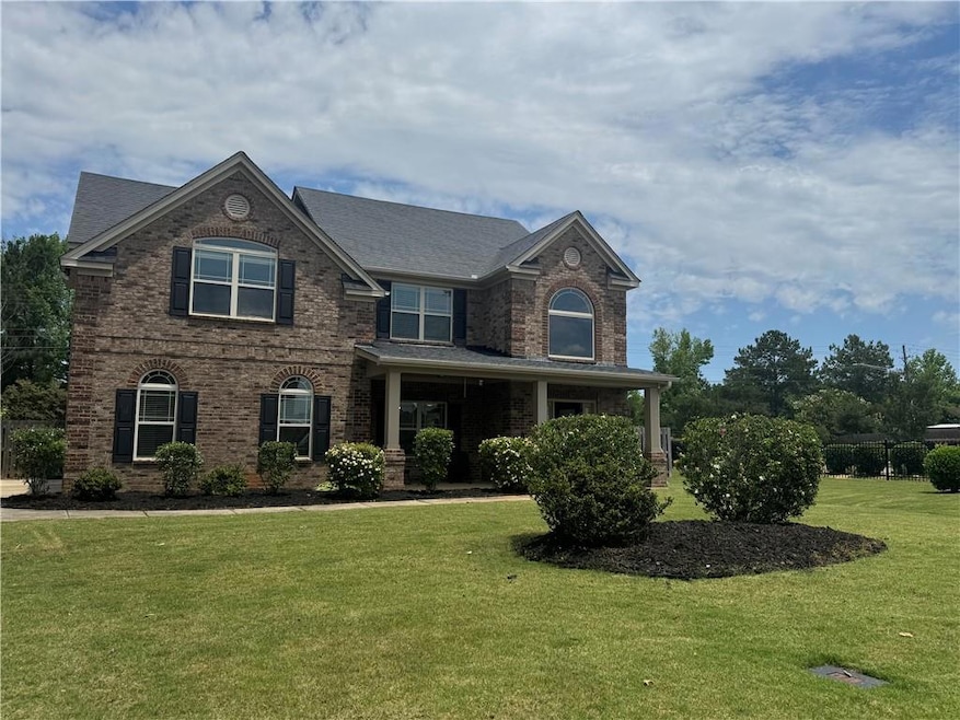View of front of house featuring brick siding and a front yard