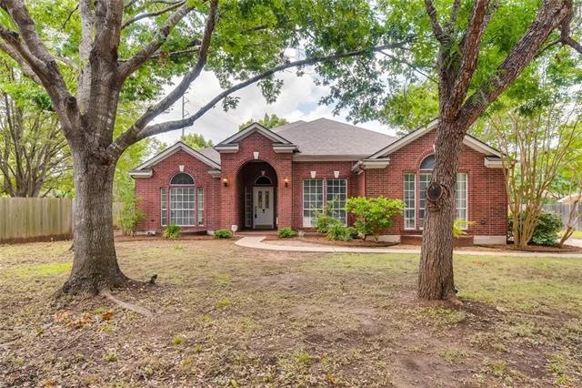 Beautiful shaded front yard with large, mature tre