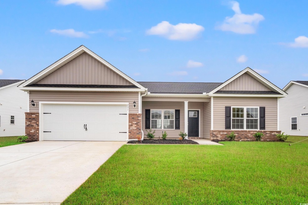 View of front of property with brick siding, board and batten siding, covered porch, and concrete driveway