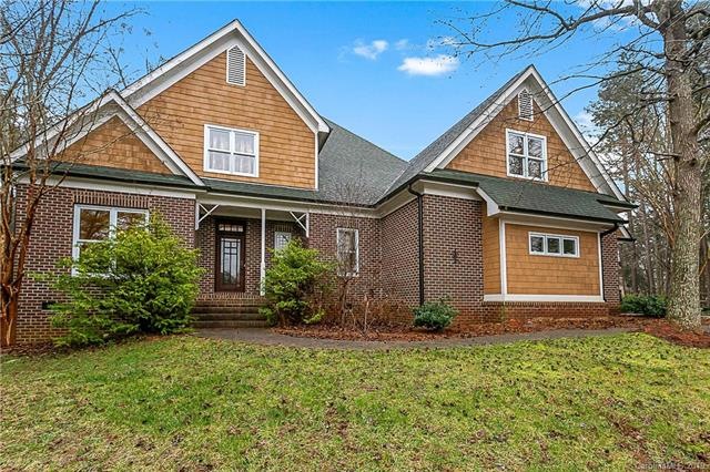 Front entrance of this brick and cedar shake siding is open and welcoming