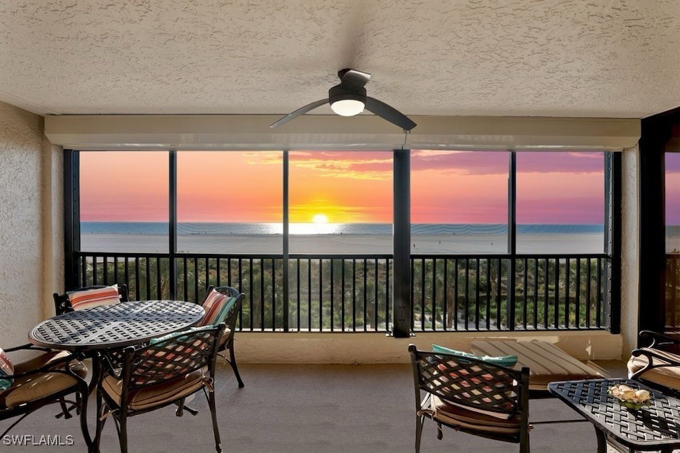 Sunroom / solarium with ceiling fan, a water view,