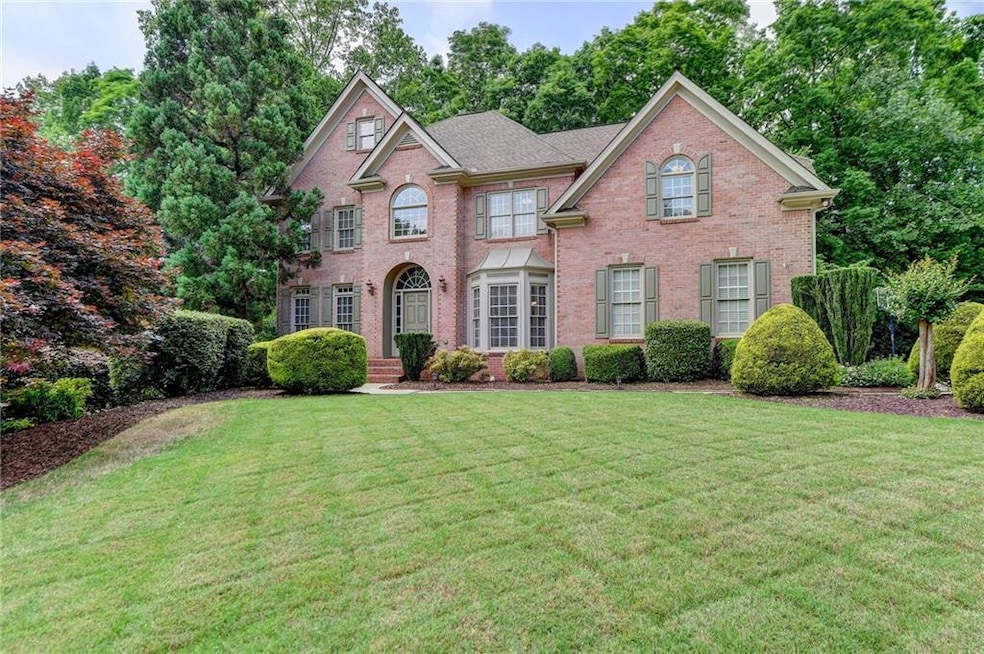 View of property featuring a front lawn