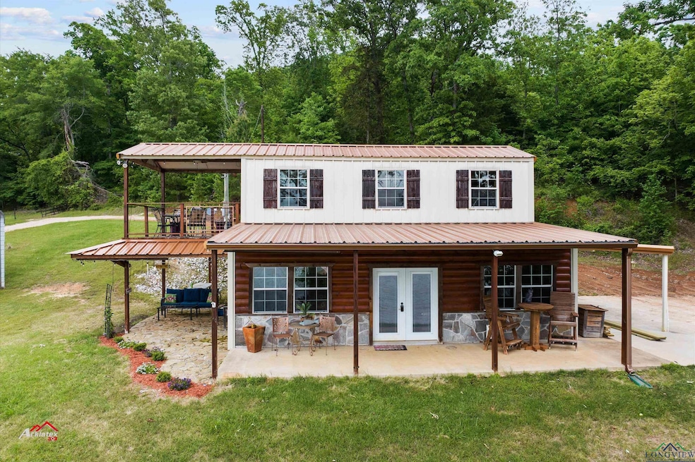 Back of house featuring a patio, a lawn, and french doors