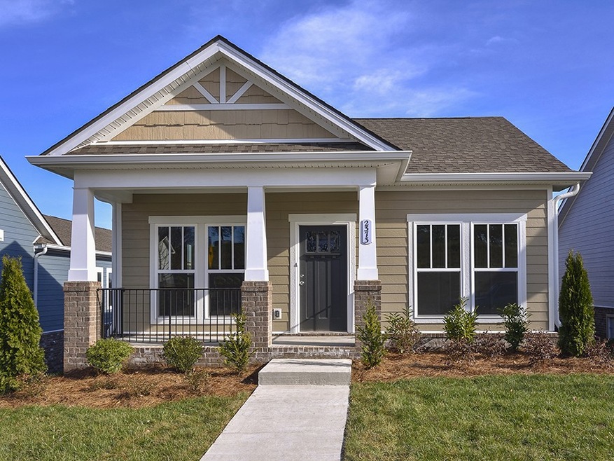 The Anniston a Charming home offering single story living 2 bedroom 2 bath with flex room,open family room and kitchen with center island, laminate floors and plush carpet, quaint rear porch, stairs leading from 2 car garage into home