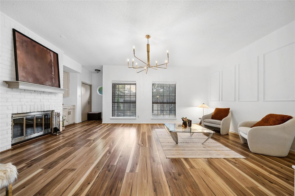 Living area featuring a chandelier, wood finished