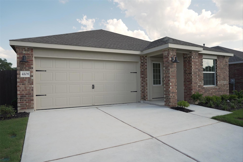 Single story home with brick siding, roof with sh