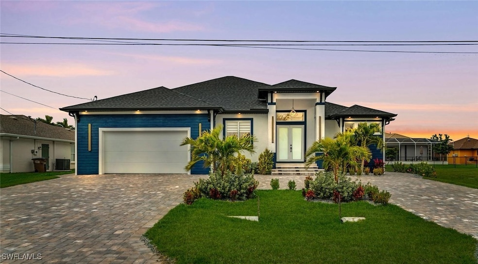 Prairie-style house with a shingled roof, a yard,