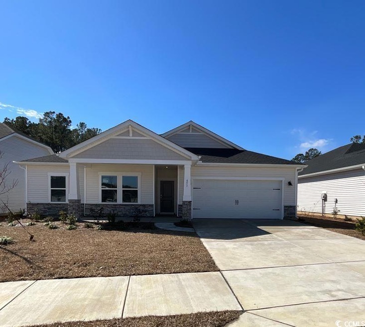 Craftsman house with stone siding, concrete drivew