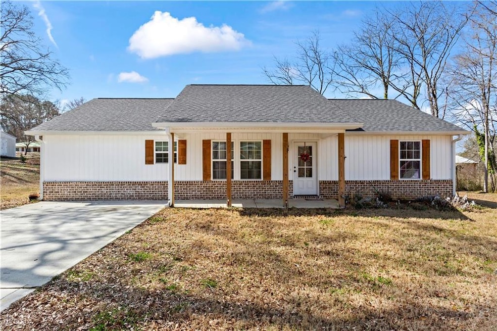 View of front of house with a porch, a front yard,