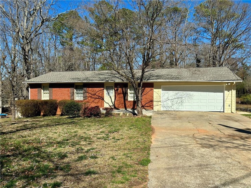 Ranch-style house featuring brick siding, a front 