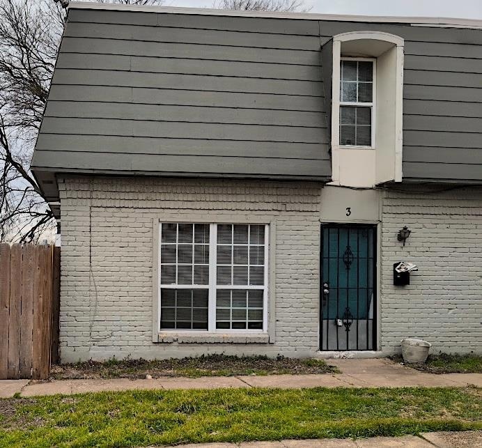 View of exterior entry featuring brick siding and