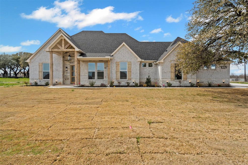 View of front of house featuring brick siding, roo