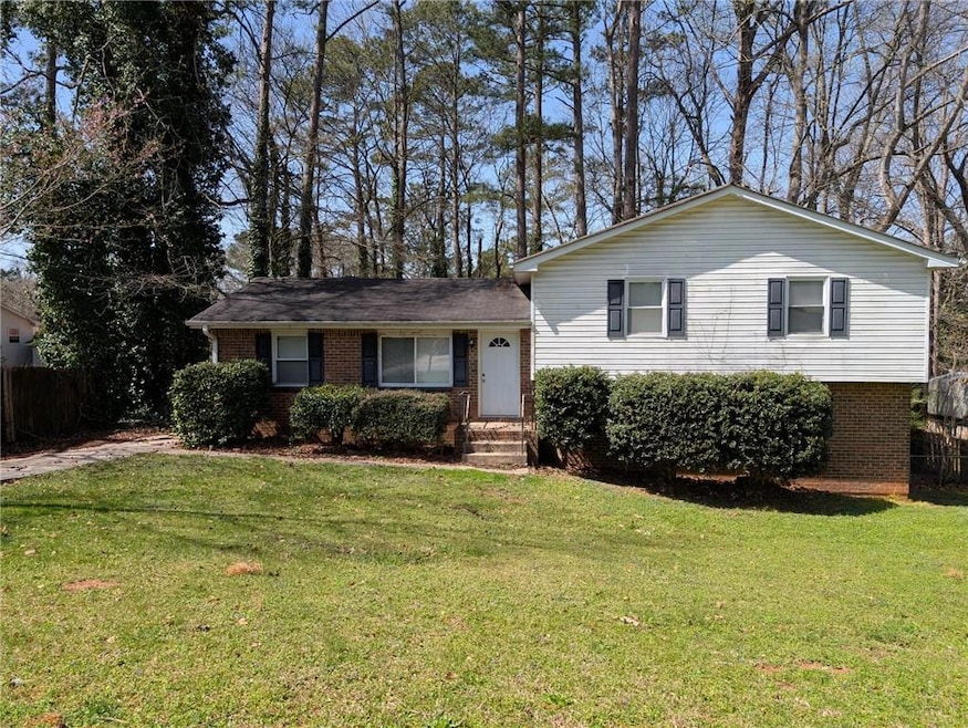 Tri-level home featuring brick siding, a front law