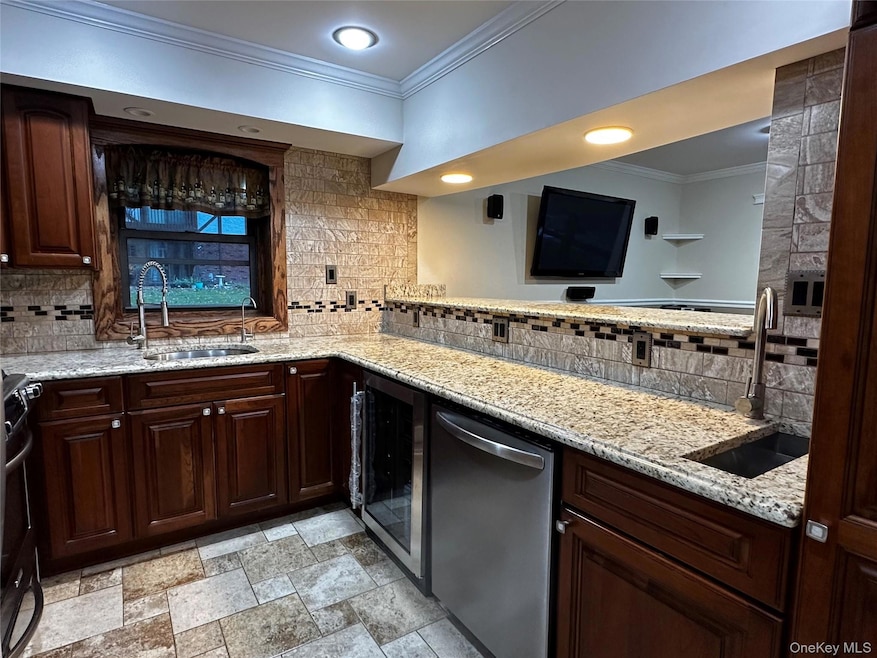 Kitchen countertop with cherry wood cabinets, granite countertops, and recessed lighting