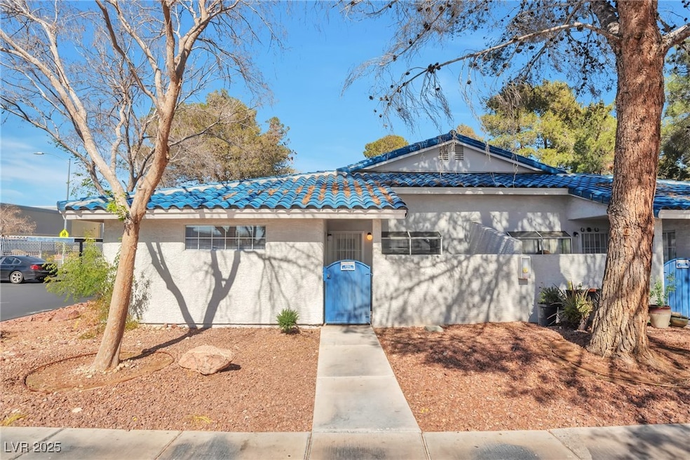 Ranch-style home with a tile roof and stucco sidin