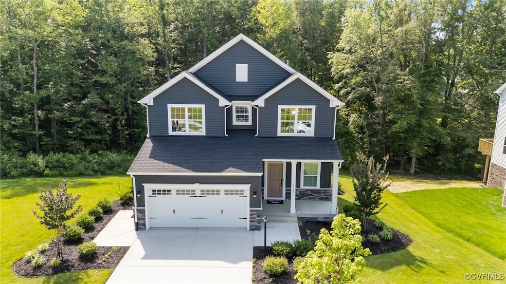 View of front of home with a garage, a front lawn,