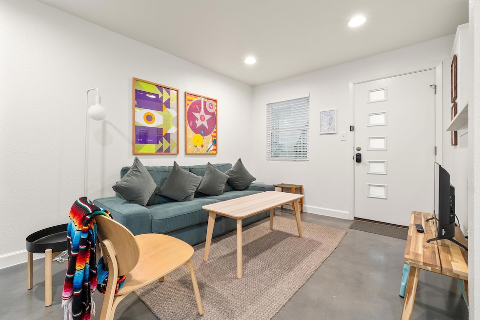 Living room with finished concrete flooring and r