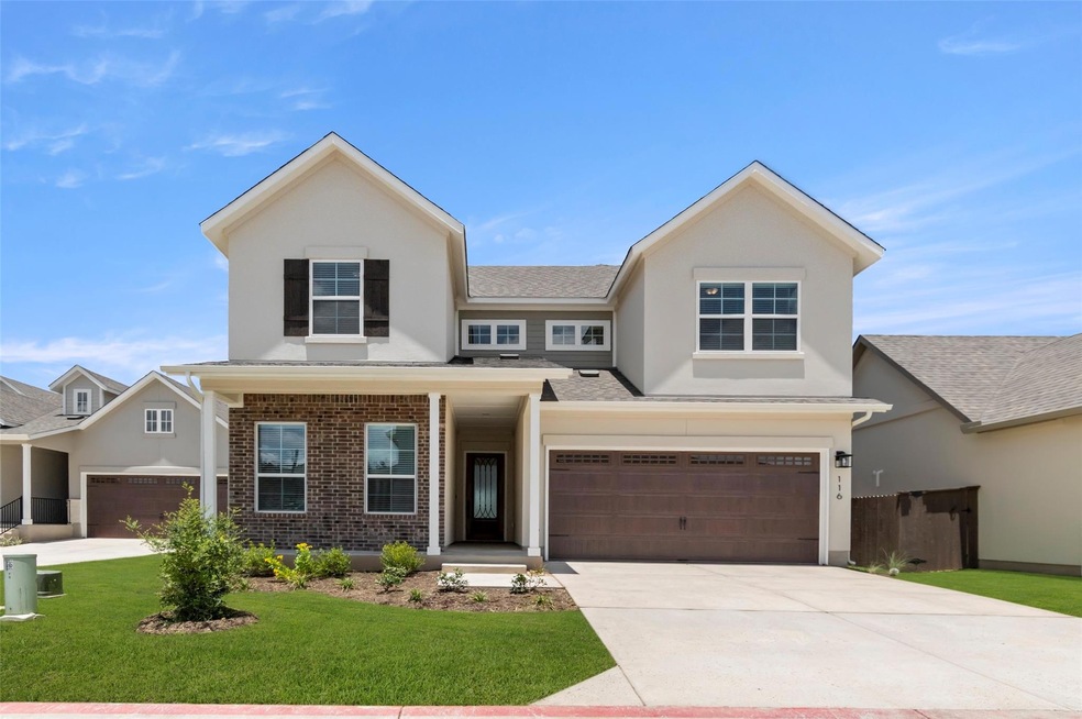 View of front of property featuring driveway, a f
