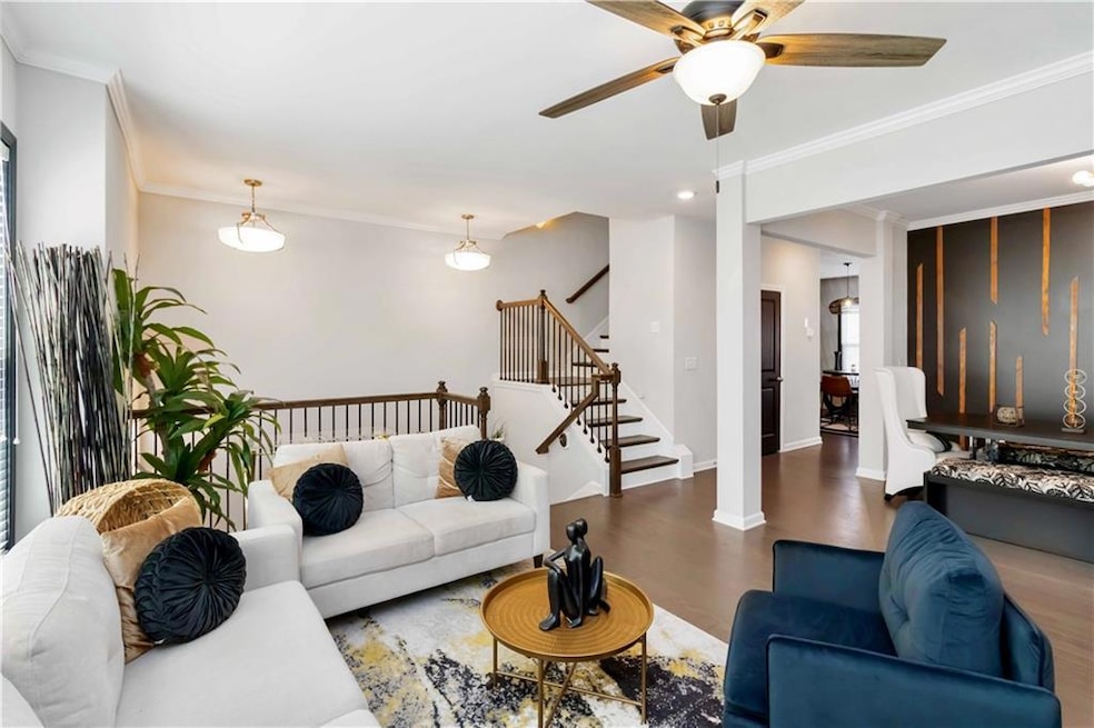 Living room with baseboards, wood finished floors,