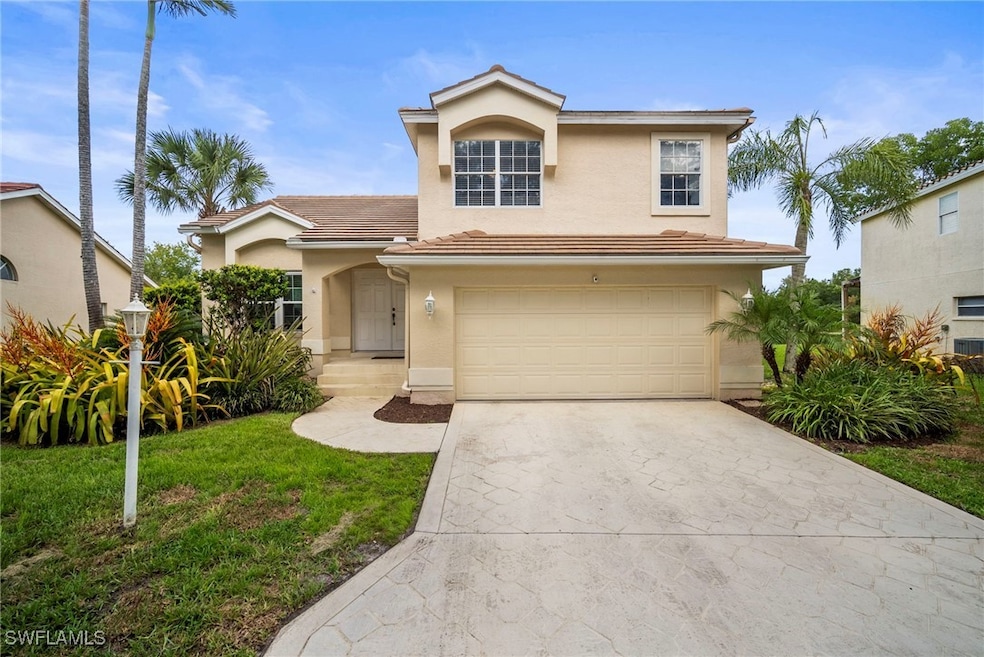 View of front facade featuring driveway, stucco siding, an attached garage, a tile roof, and a front lawn