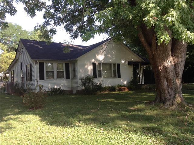 Charming Cottage with beautiful shade trees in front and back yard.