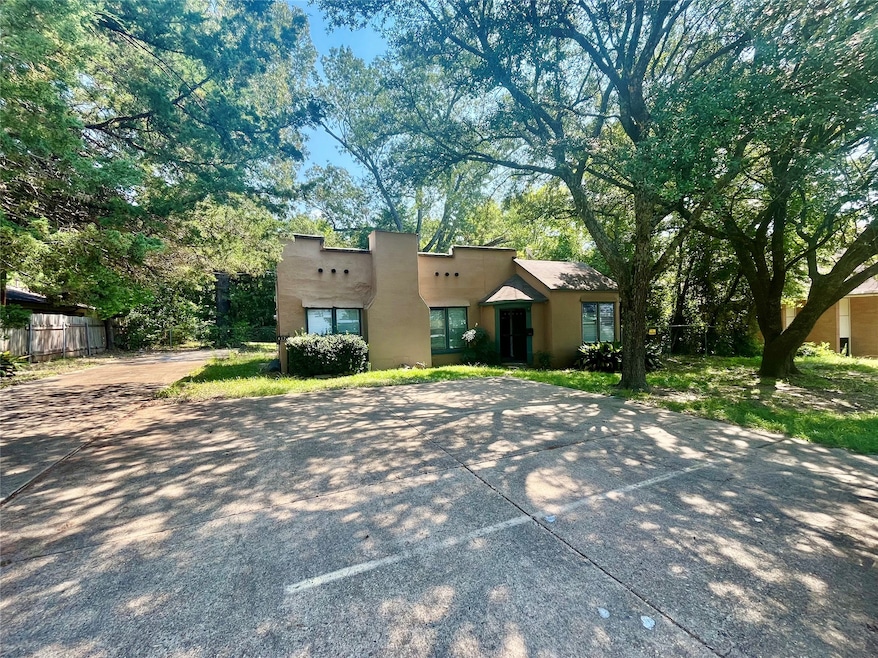 View of front of property featuring stucco siding and concrete driveway