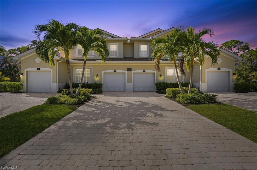 View of front of house featuring decorative driveway and stucco siding