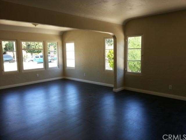 Another view of living room with beautiful dark wo