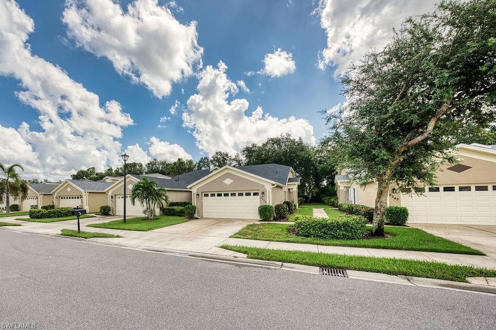 View of front of home featuring concrete driveway, a garage, a residential view, stucco siding, and a front lawn
