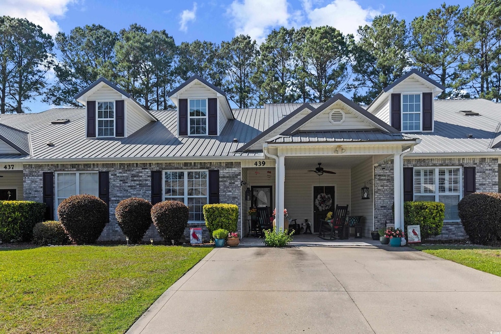 View of front facade with ceiling fan, a front yar