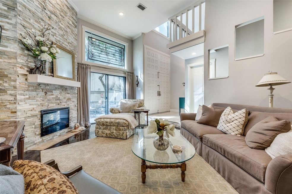 Living room featuring a fireplace, crown molding, 