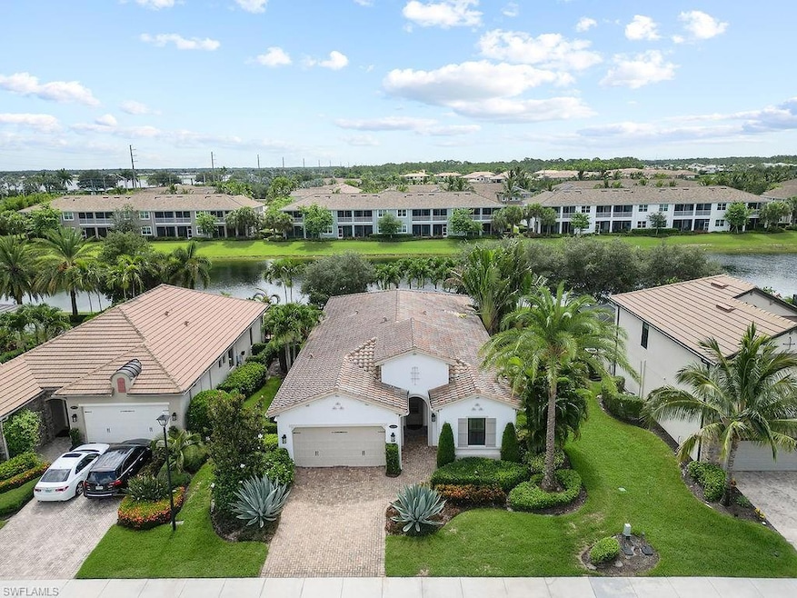 Birds eye view of property with a water view