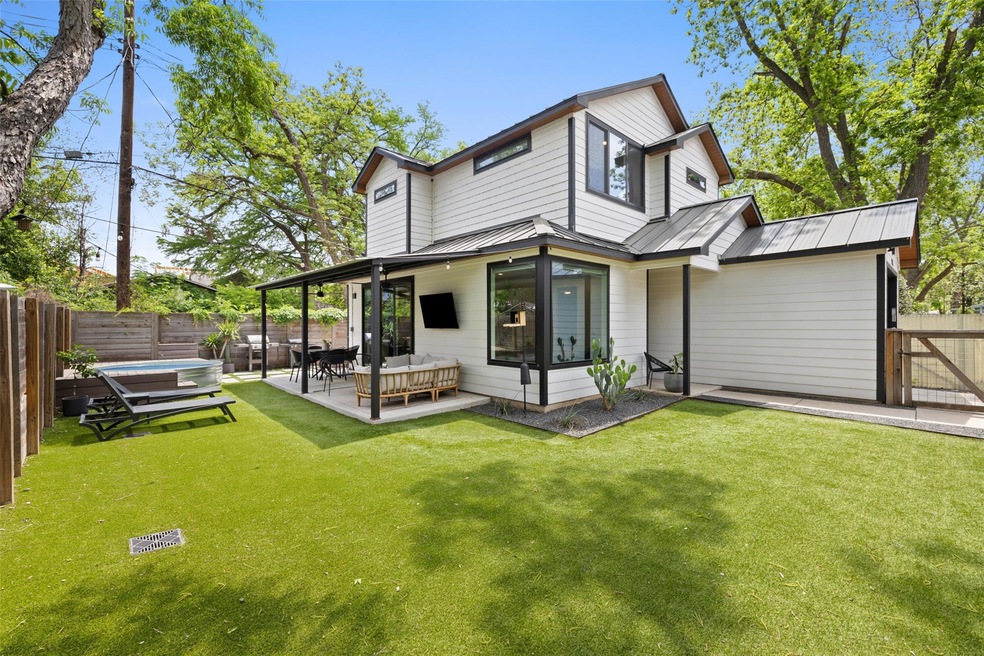Rear view of house featuring metal roof, an outdo