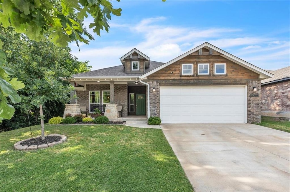 Craftsman inspired home with a front lawn, concrete driveway, brick siding, a garage, and a shingled roof