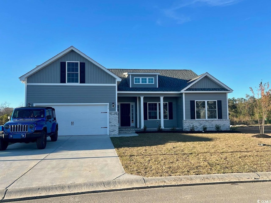 Craftsman house with a garage and a front yard
